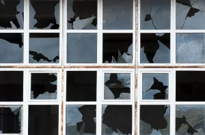 Deserted Exterior View Prints: Broken windows of old building. White frames