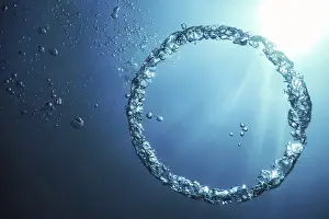 Deserted Ocean Scene Prints: Bubble Ring Underwater ascends towards the Sun