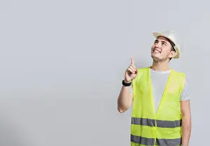 Adult Male Construction Worker Prints: Builder engineer pointing finger to the right isolated