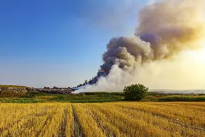 Climate Change Impact Prints: Burning garbage dump pollutes the environment