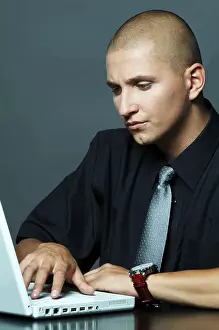 Business Attire Man Prints: A businessman using laptop computer
