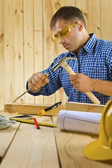 Construction Worker Prints: Carpenter works with the chisel