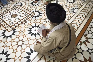 Indian Traditional Costume Prints: Sikh devotee reading holy scriptures Nanded