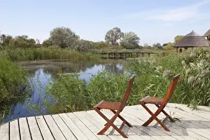 Danube Delta Biosphere Reserve Prints: Two chairs on viewing platform at the lagoon
