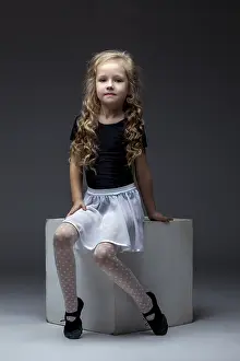 Female Sporty Pose Prints: Charming curly performer posing in studio on gray background
