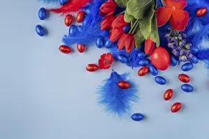 Christian Easter Traditions Prints: Cheerful Easter decoration with a red egg surrounded by tulips and feathers