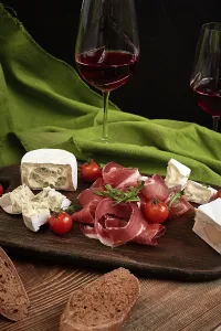 Rustic Wooden Board Still Life Prints: Cheese and meat appetizer selection