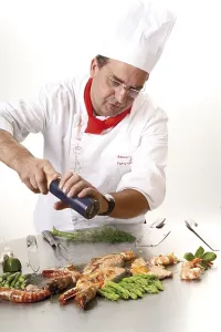 Prints of Chef adding pepper at a teppan grill, ingredients: king prawns, salmon steaks, green asparagus and garlic King Prawn Prints: Chef adding pepper at a teppan grill Print