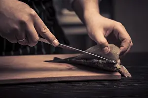 Kitchen Device Images Prints: Chef cutting the fish on a board