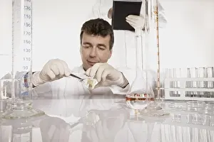 Laboratory Equipment Prints: Chemist conducting an experiment in a lab