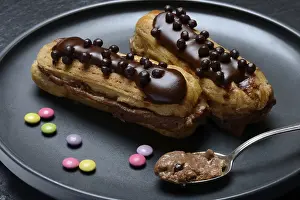 Chocolate Eclairs Prints: Two chocolate eclairs on a plate