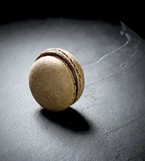 Dark Background Dessert Prints: Chocolate macaron at the black background