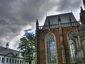 European Architecture Style Prints: Church with Gothic architecture and high windows against a dramatic