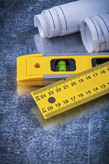 Close Up Blueprints Prints: Close up image of rolled up blueprints ruler