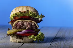 Fast Food Photography Prints: Close-up of a single cheeseburger