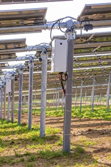 German Farmland Photography Prints: Close-up of solar panel structures with electrical components on green field