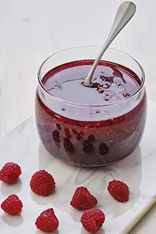 Organic Cultivation Prints: Close up view of transparent pot with raspberry jam