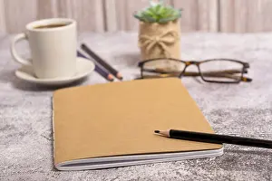 Empty Desk Setup Prints: Closed notebook with brown covers