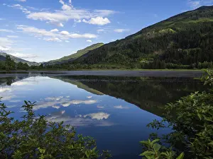 Images Dated 13th June 2024: Clouds are reflected in the lake Print, Gaishorn am See, Austria
