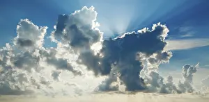 Red Sky At Sunrise Prints: Clouds in sky with sunrays on sunrise