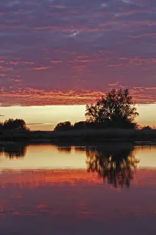 European Cloud Formations Prints: Clouds in the sunset with reflection on the river Trebel