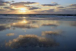 Coastal Sunset Prints: Cloudy reflection in coastal waters at sunset