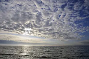 Baltic Sea Evening Atmosphere Prints: Cloudy sky, cloud formations in front of the setting sun