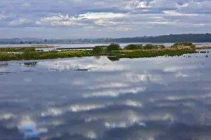 Overcast Sky Landscape Shot Prints: Cloudy sky landscape reflected in a vast