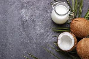 Tropical Fruit Photography Prints: Coconut shell and milk over black rustic background