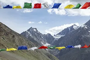Mountain Trekking Adventure Prints: Colorful prayer flags flutter in the foreground