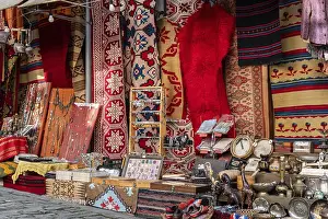 Prints of Colourful bazaar stand with carpets, jewelry and handicrafts in Gjirokastra, Gjirokaster District, Albania Colourful bazaar stand with carpets, jewelry and handicrafts in Gjirokastra Related Prints: Colourful Bazaar Stand Print, Gjirokastra, Albania