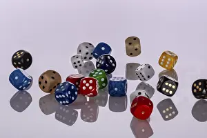 Deserted Scene Prints: Many colourful playing cubes fall jumbled on a bright surface