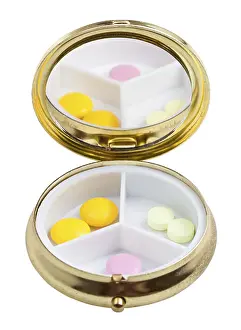 Healthcare System Prints: Compact pill box with mirror and multiple tablets against white background