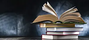Educational Institution Prints: A composition with an open book lying on a stack of other books