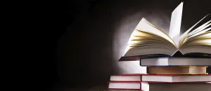 Deserted Library Scene Prints: A composition with an open book lying on a stack of other books