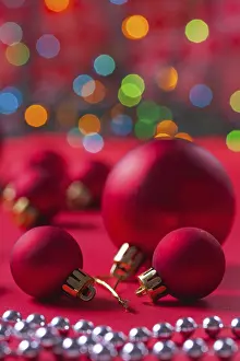 Festive Holiday Lighting Prints: Composition of red christmas balls on red table