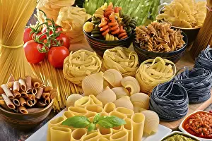 Tomato Based Pasta Recipes Prints: Composition with variety of pasta on kitchen table
