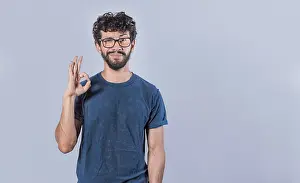 Positive Body Language Prints: Concept of no problem, young man making ok gesture