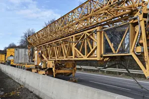Construction Crane Prints: Construction crane and low loader at a building site