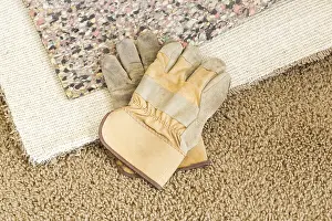 Deserted Living Room Prints: Construction gloves on pulled back carpet and underlay in room