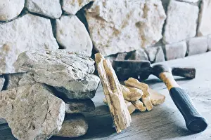 Fortress Architecture Prints: Construction Hammer And Stack Flagstone Against The Wall Of Stone Closeup