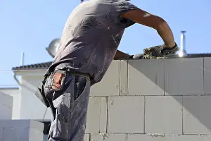 New Building Site Prints: Construction worker (bricklayer) on the building site