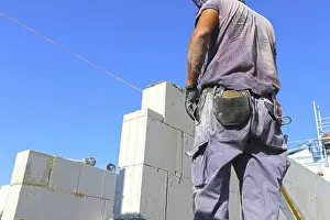 New Building Site Prints: Construction worker (bricklayer) on the building site