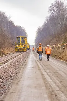 Deserted Construction Site Europe Prints: Construction worker on a rail line in the forest