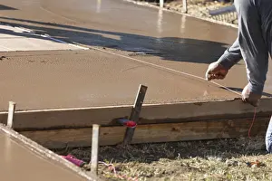 Directional Sign Prints: Construction worker snapping line into wet deck cement