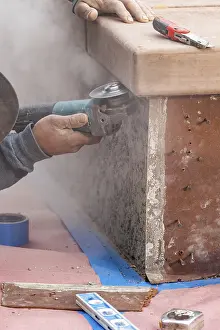 Manpower In Construction Prints: Construction worker using grinder at construction site