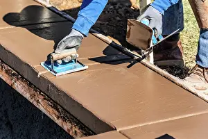 Industrial Building Construction Prints: Construction Worker Using Hand Groover On Wet Cement Forming Coping Around New Pool