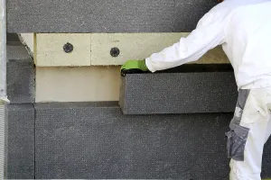 Building Facade Design Prints: Construction workers insulate a house facade