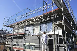 Construction Site Laborer Prints: Construction workers insulate a house facade