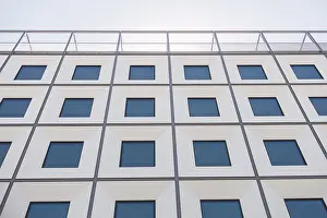 Symmetrical Architectural Style Prints: A contemporary building facade with a geometric pattern of windows creates a striking visual effect